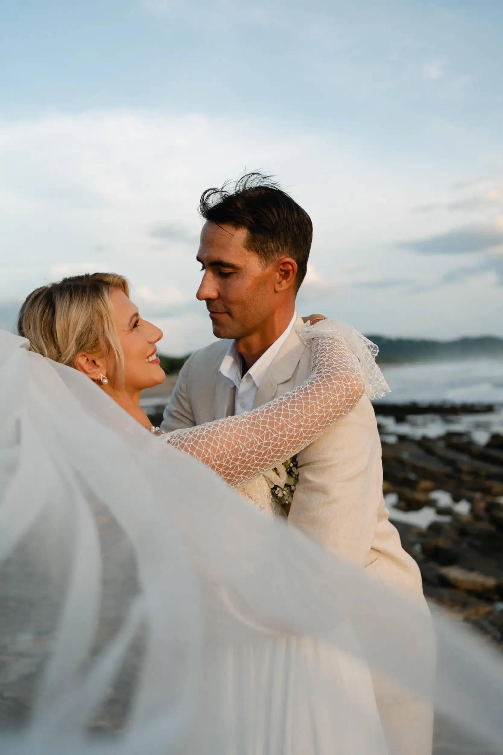 Bride and groom embracing during a romantic beachfront wedding at sunset in Popoyo, Nicaragua