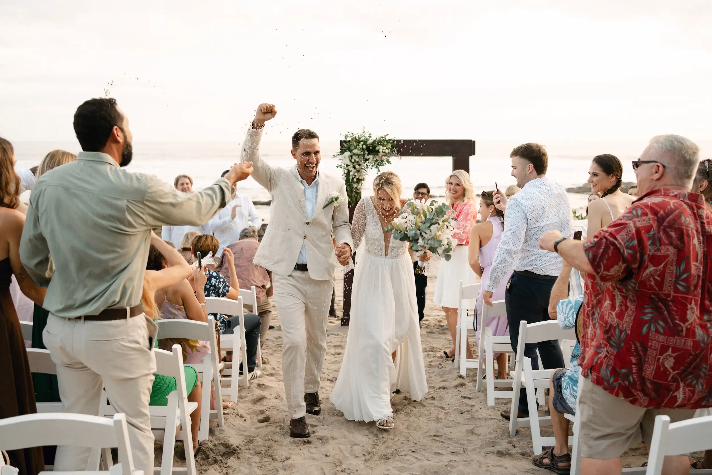 Joyful beach wedding ceremony at Magnific Rock in Popoyo, Nicaragua