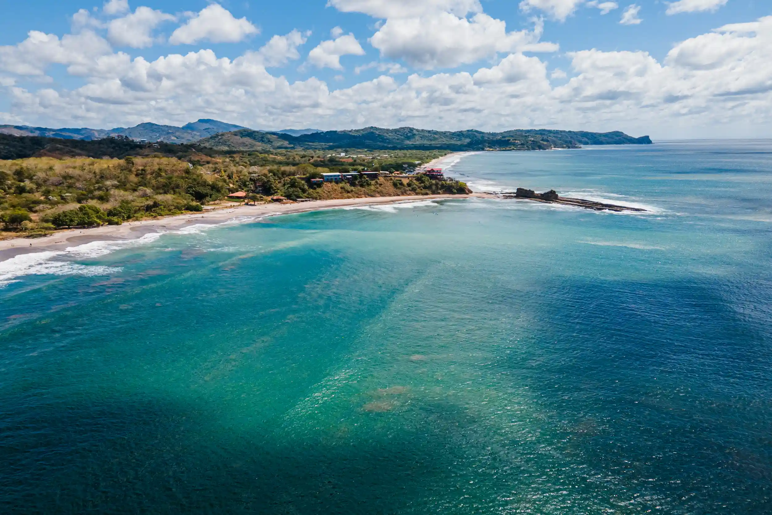 Panoramic aerial view of the pristine coastline and tropical beaches surrounding Magnific Rock in Popoyo, Nicaragua